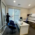E3R team member cleaning an office window