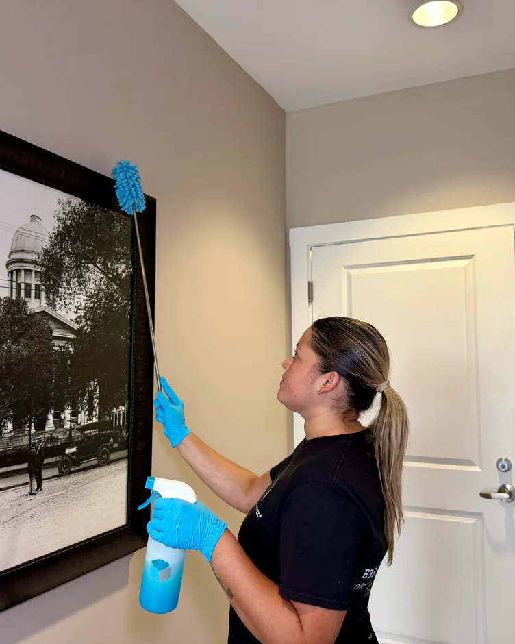 E3R team member wiping a mirror in an apartment