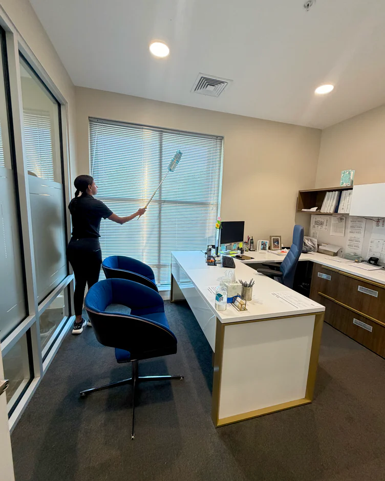 E3R team member cleaning an office window