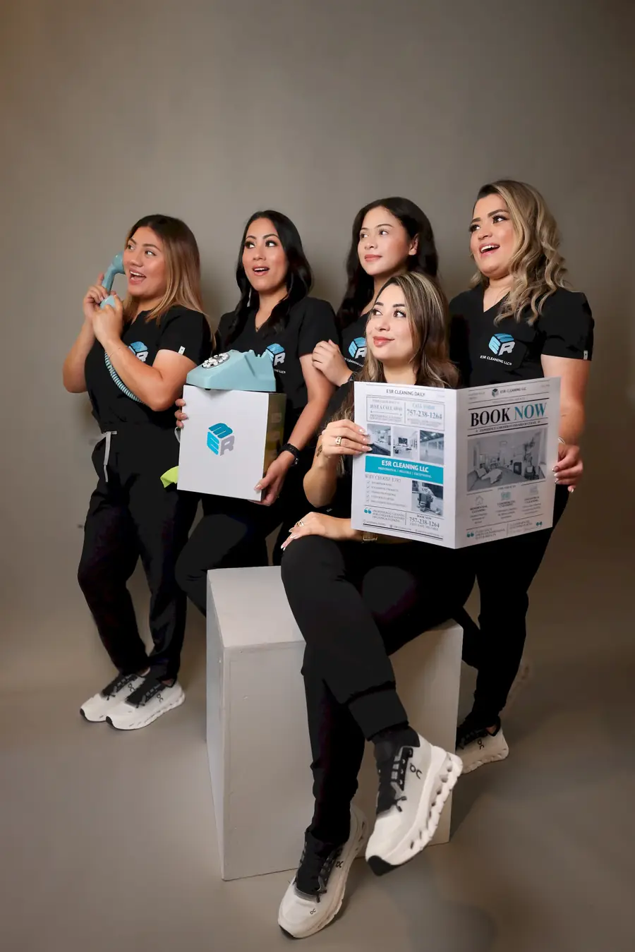Five members of the E3R Cleaning team in black uniforms